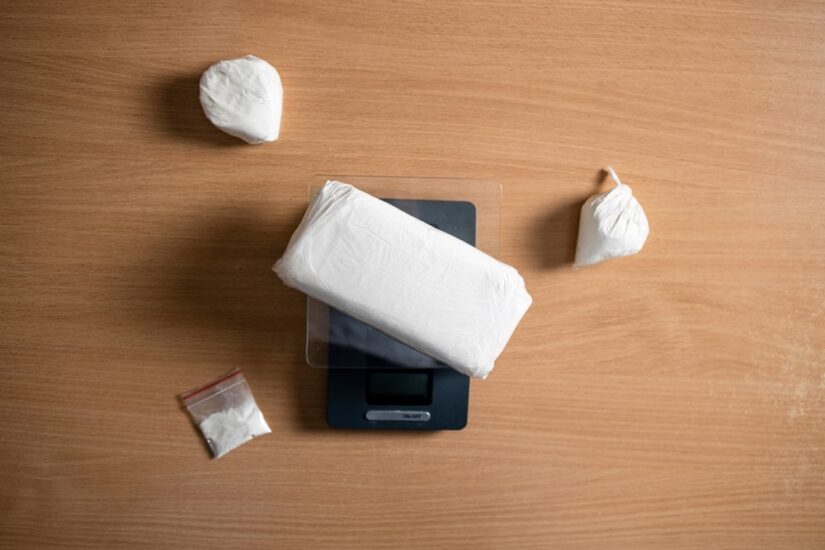 Drug Scales White Packets Og Drugs On A Table Alongside With Scales