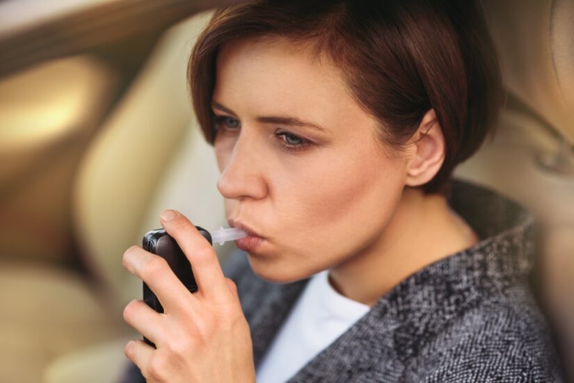 Woman Doing A Breathalyzer Test